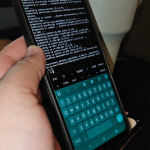 a-hand-holding-a-phone-showing-termux-downloading-and-installing-packages
