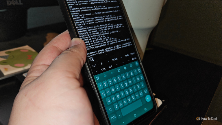 a-hand-holding-a-phone-showing-termux-downloading-and-installing-packages