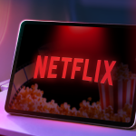 a-tablet-on-an-airplane-tray-table-showing-the-netflix-logo-with-haze