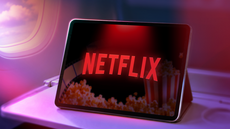 a-tablet-on-an-airplane-tray-table-showing-the-netflix-logo-with-haze