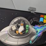 image-of-ubuntu-running-on-a-pc-with-a-wallpaper-showing-the-linux-mascot-tux-riding-with-an-alien-in-a-ufo