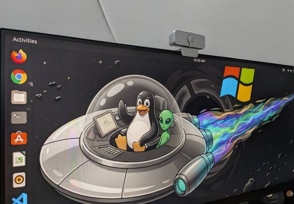 image-of-ubuntu-running-on-a-pc-with-a-wallpaper-showing-the-linux-mascot-tux-riding-with-an-alien-in-a-ufo