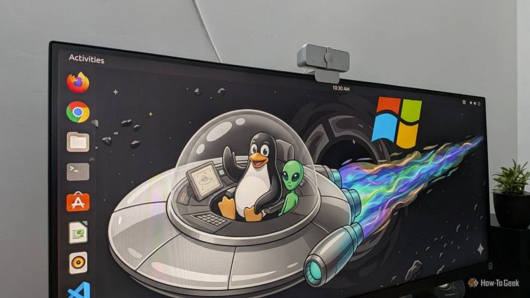 image-of-ubuntu-running-on-a-pc-with-a-wallpaper-showing-the-linux-mascot-tux-riding-with-an-alien-in-a-ufo