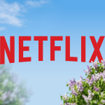 netflix-logo-against-a-clear-blue-sky-with-blurred-purple-flowers
