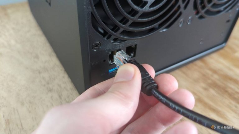 person-s-hand-plugging-an-ethernet-cable-into-a-synology-ds425-nas-2